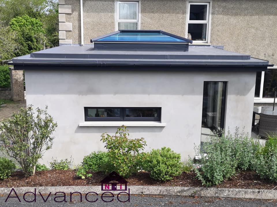 Single-storey sunroom extension with grey tiled roof and roof lantern