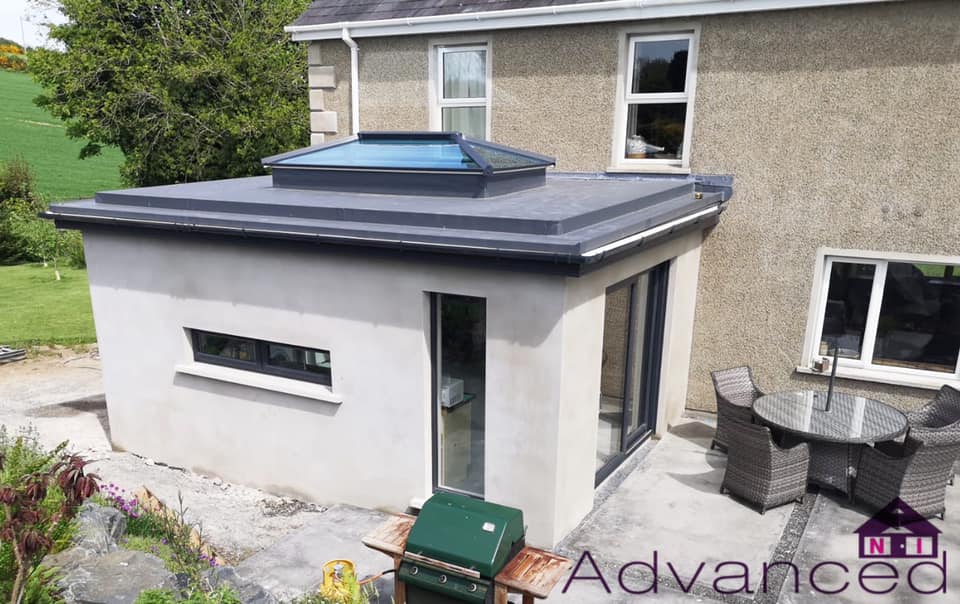 Rendered sunroom extension with grey tiled roof