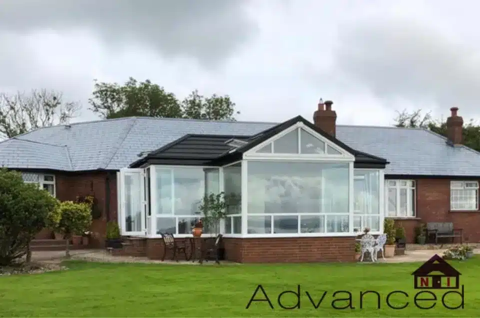 Front view of a conservatory with a new dark tiled roof