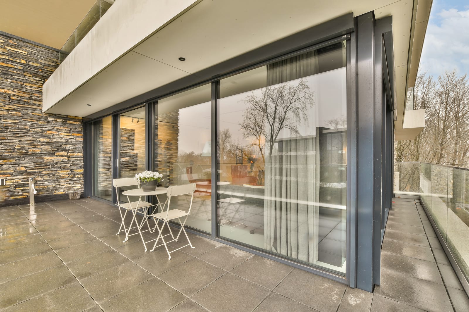 Large sliding patio doors opening onto a covered terrace