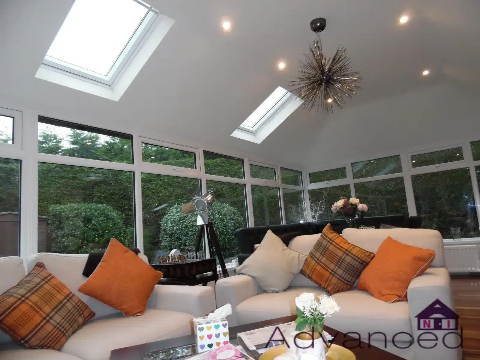 Bright conservatory interior with roof lights and garden views