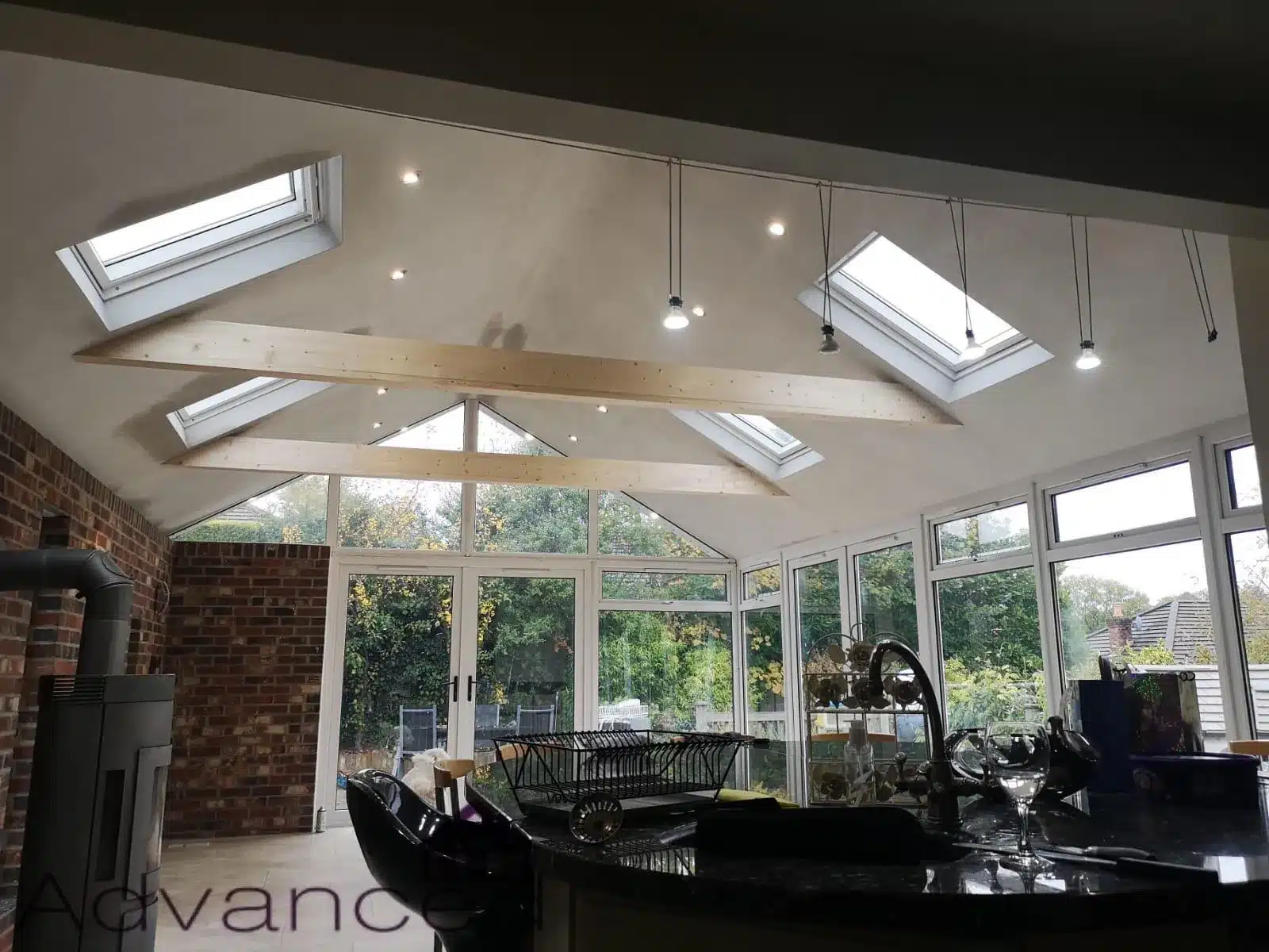 Open-plan conservatory kitchen with multiple roof lights