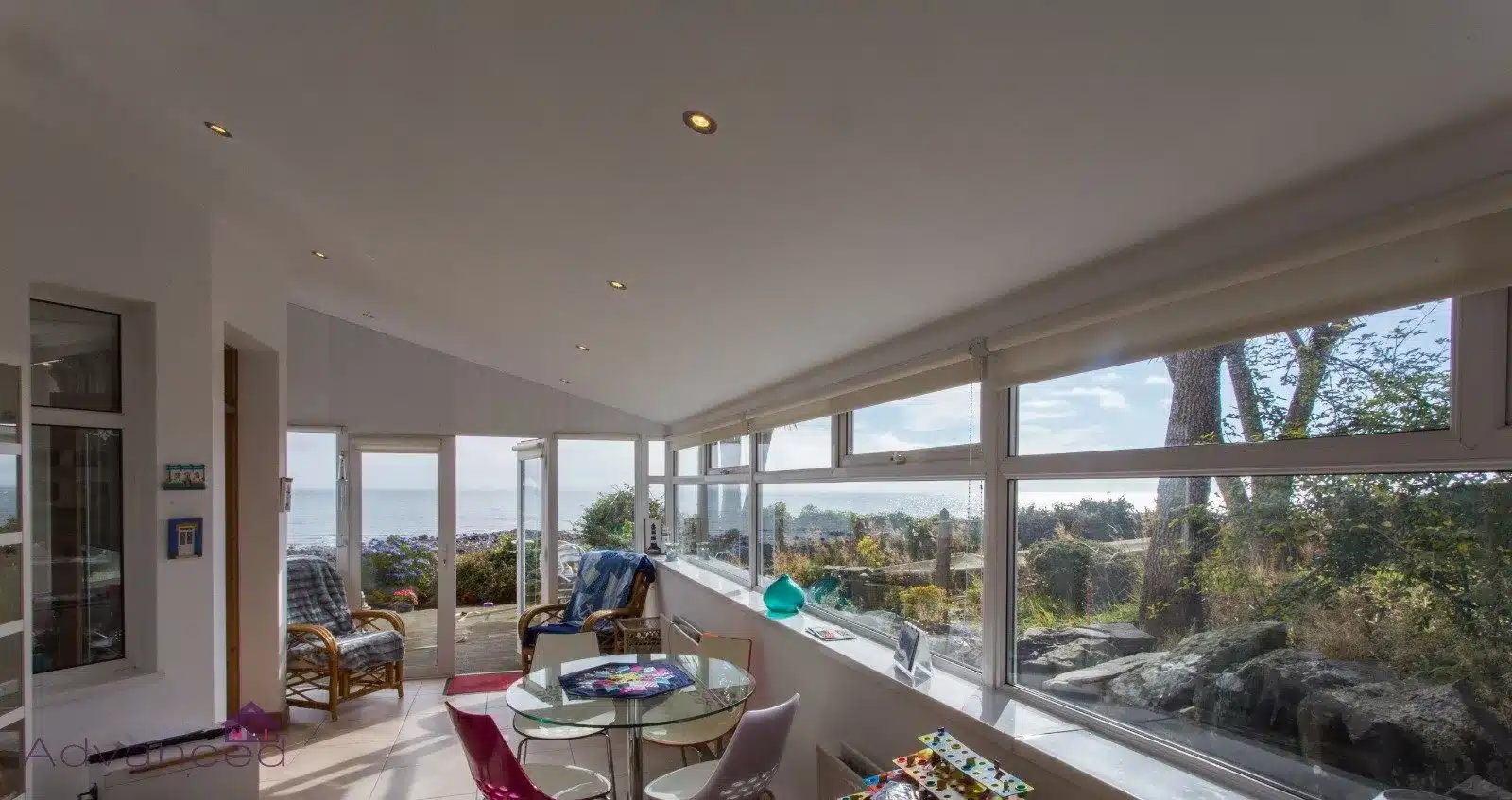 Wide sunroom interior with floor-to-ceiling windows