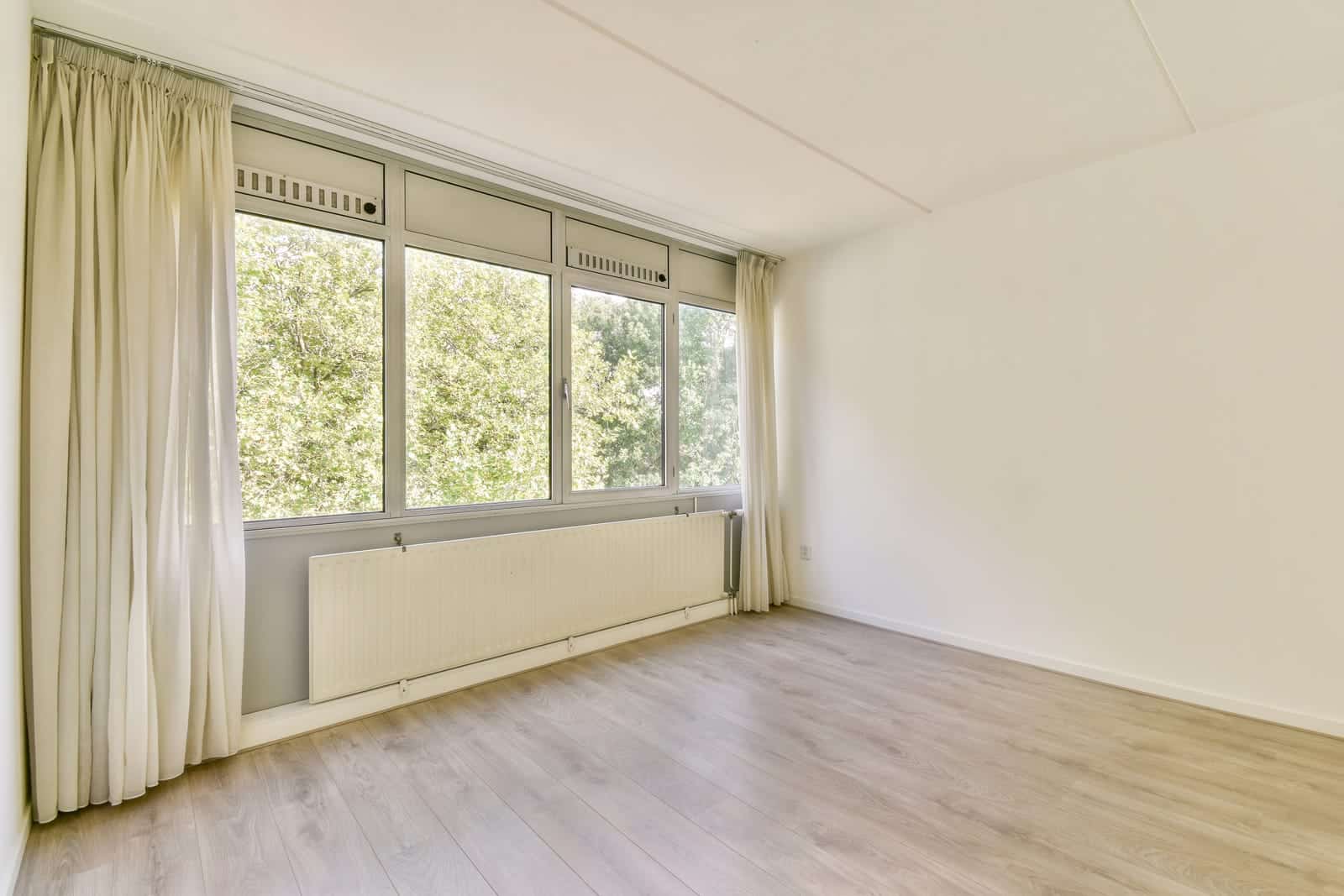 Bright empty room with wide white-framed windows