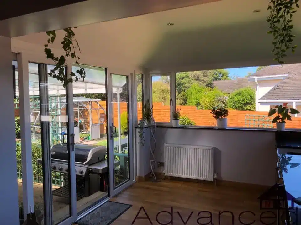 Open-plan sunroom with patio doors and wide windows