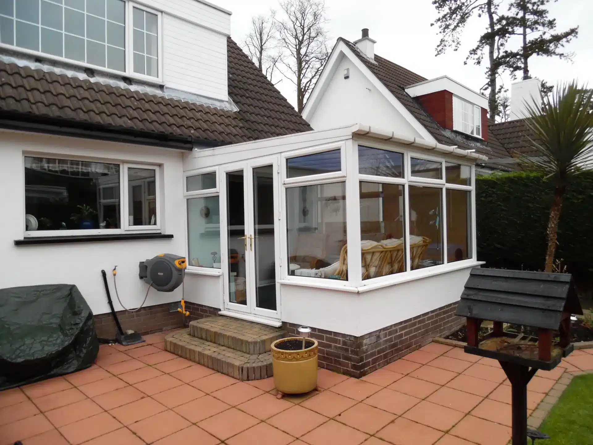 White conservatory with a polycarbonate roof before conversion