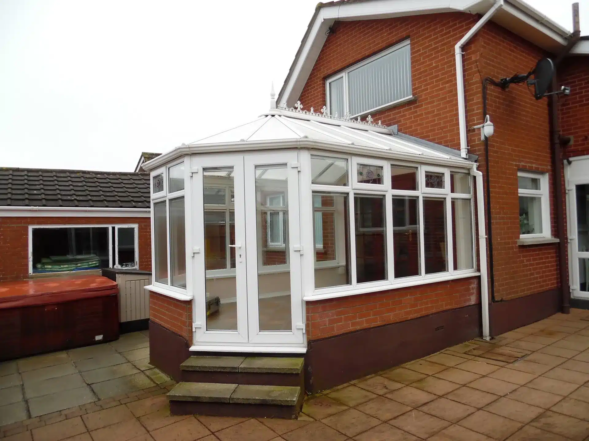 White conservatory with glazed roof before conversion