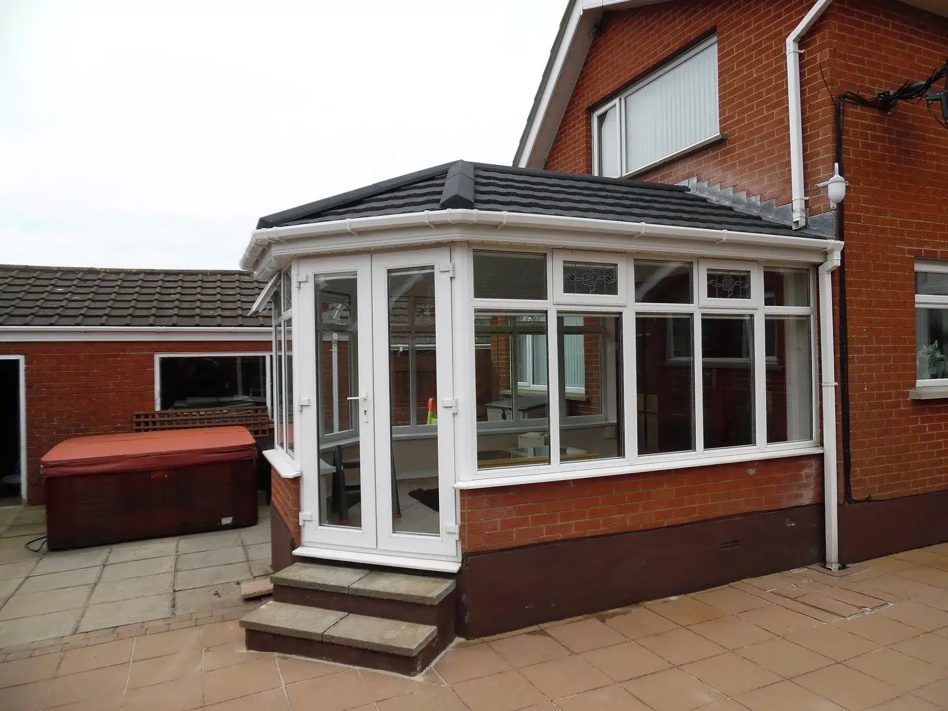 White conservatory after a dark tiled roof conversion