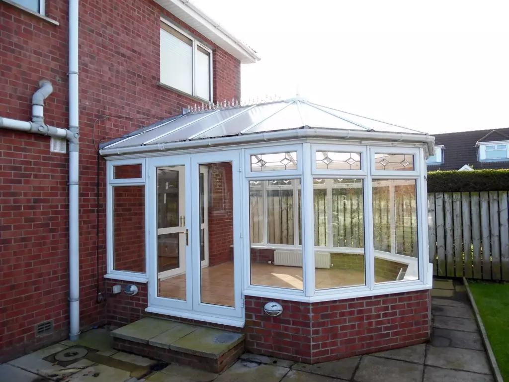 White conservatory with glazed roof before conversion