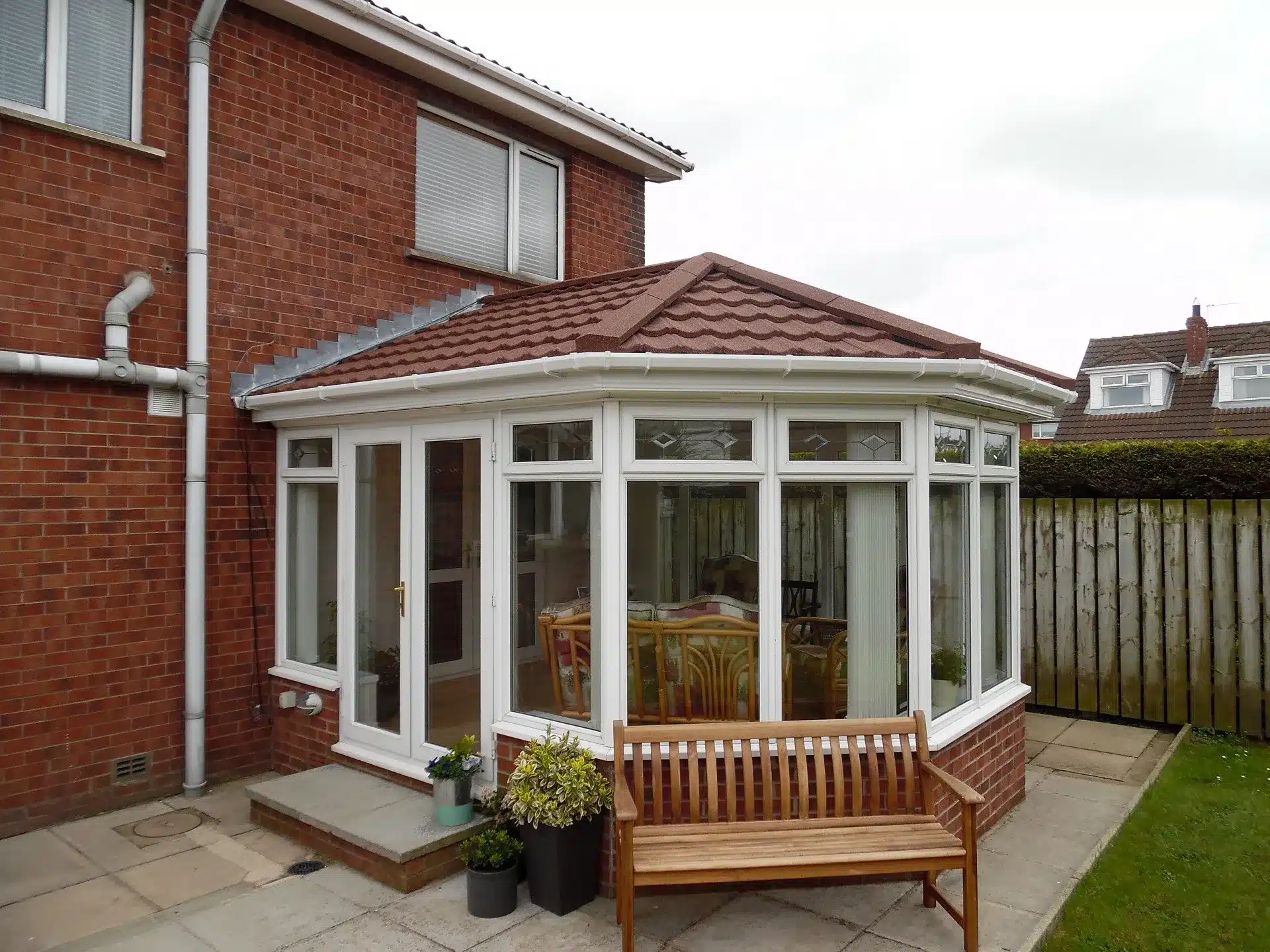 White conservatory after a brown tiled roof conversion