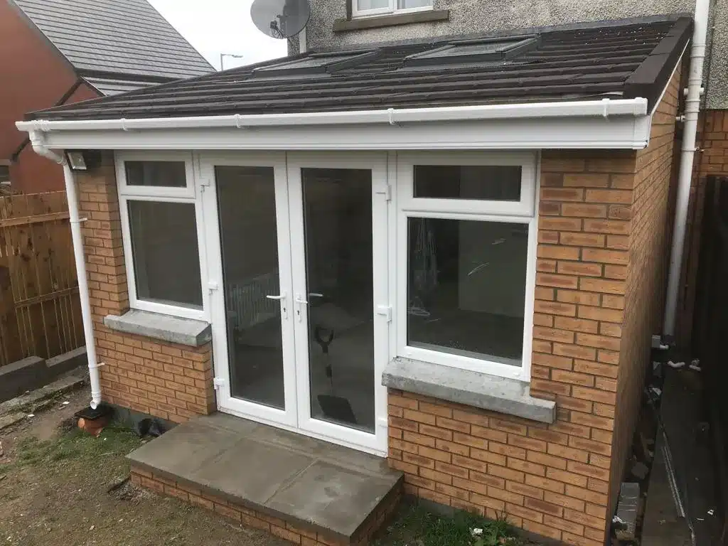 New sunroom with white French doors and windows in Bangor