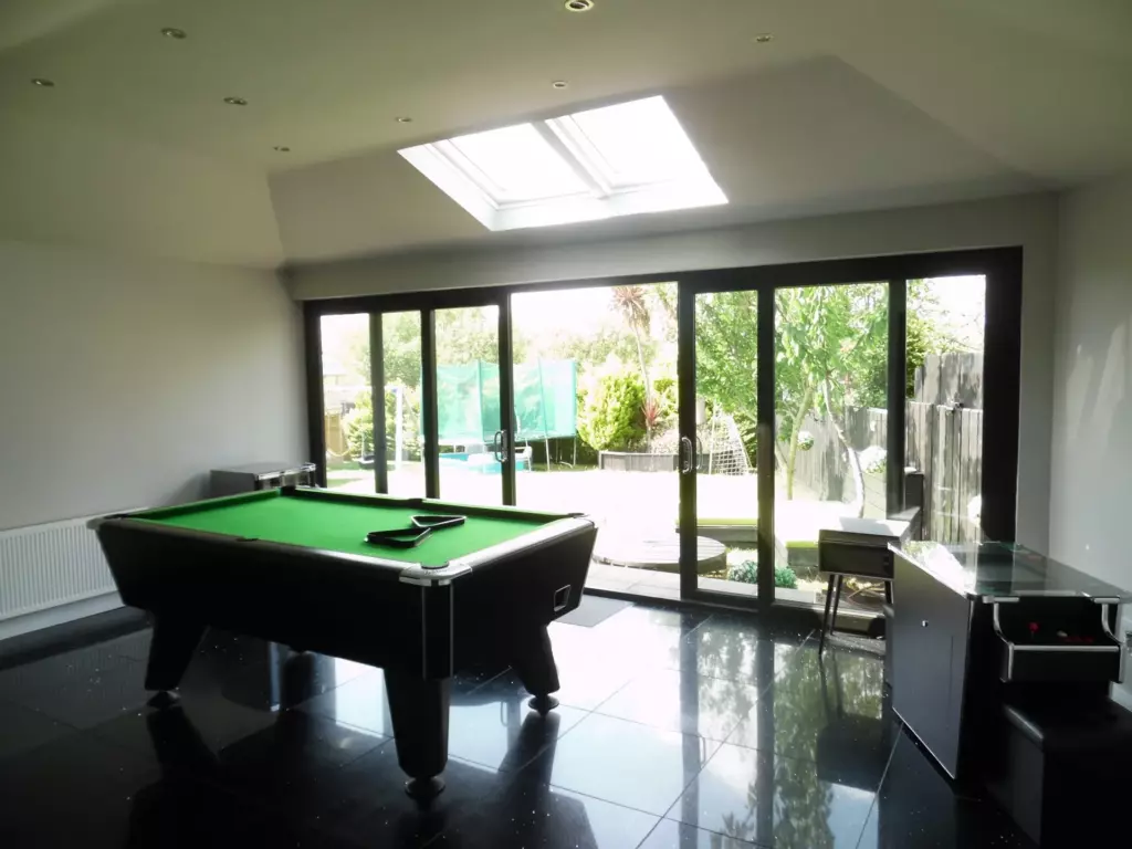 Games room with a pool table inside a converted conservatory