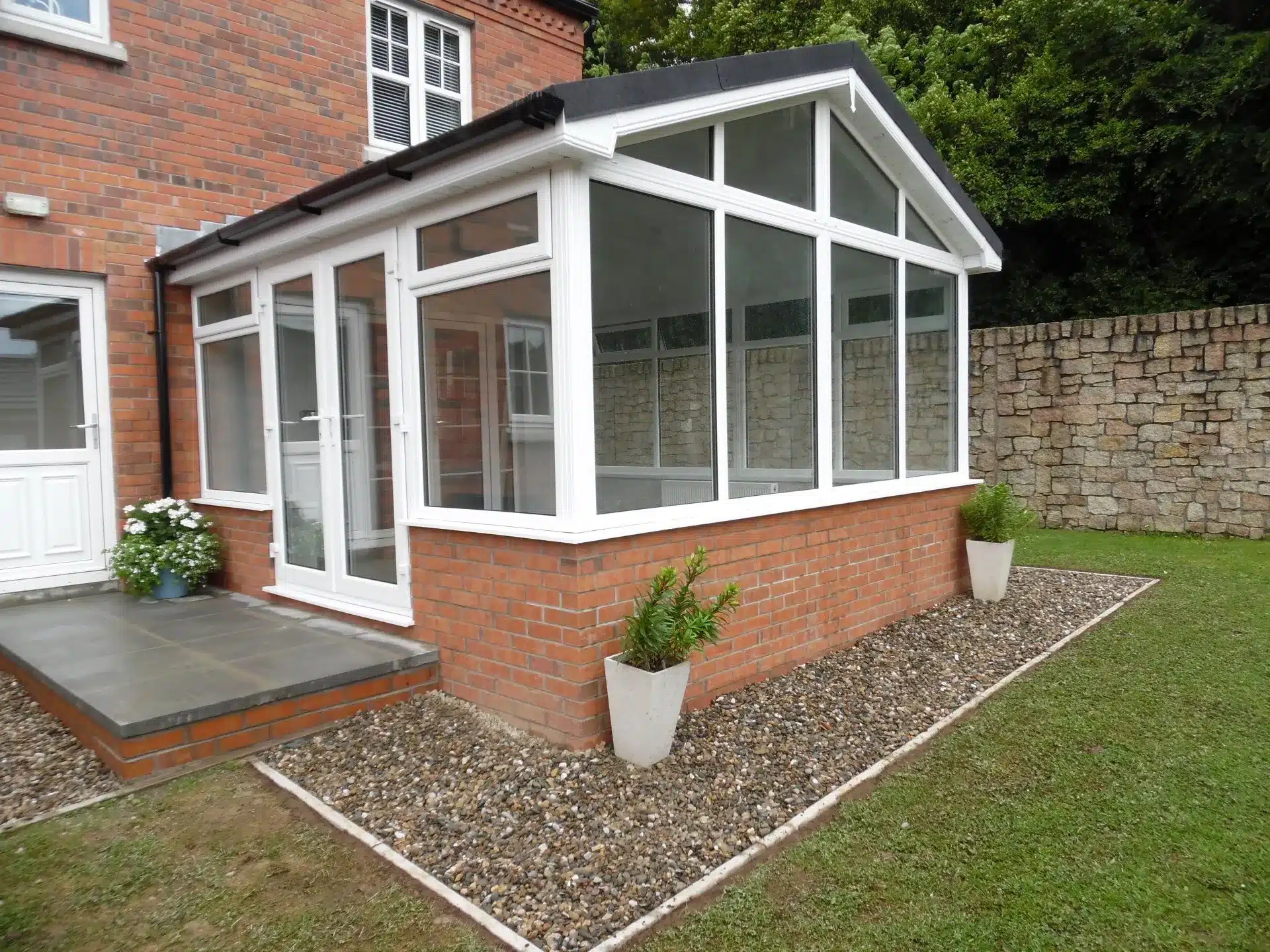 White sunroom extension with a glazed roof