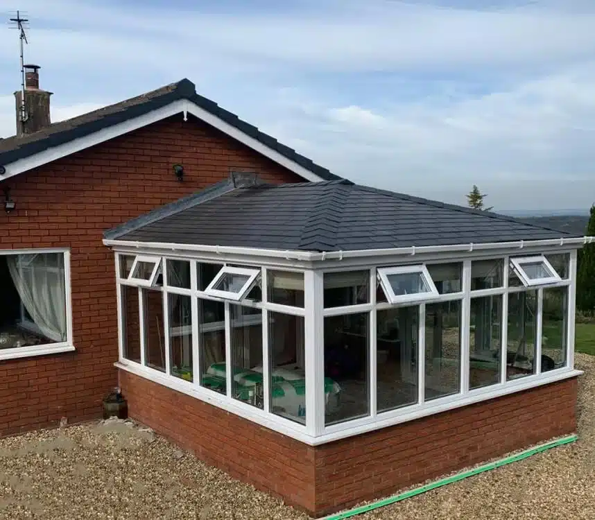 White conservatory extension with a glazed roof